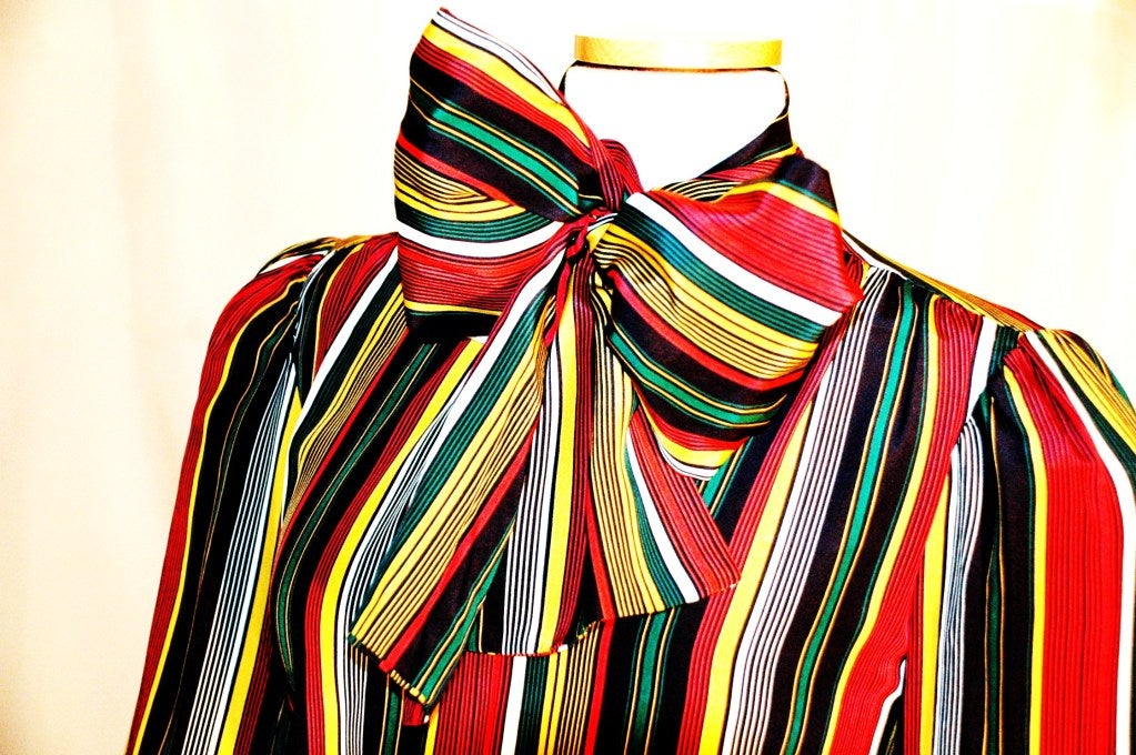 This is an incredible Yves Saint Laurent Rive Gauche multi color stripes print 100% silk blouse with attached scarf. Size 38
Measurements:
Bust 40