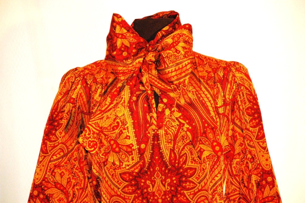 This is an incredible Yves Saint Laurent Rive Gauche electric gorgeous print 100% silk long sleeve blouse with attached scarf. Size 38
Measurements:
Bust 40