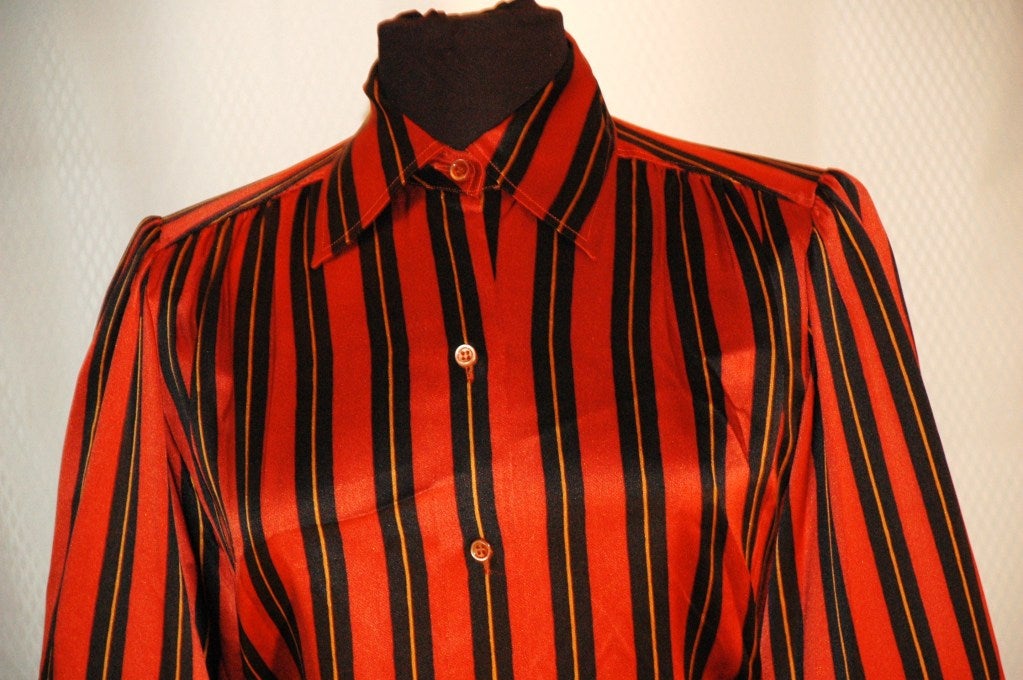 This is a gorgeous vintage Yves Saint Laurent Rive Gauche 1Red Black Gold 100% silk blouse. Made in France.  Size 38
Measurements:
Bust 40