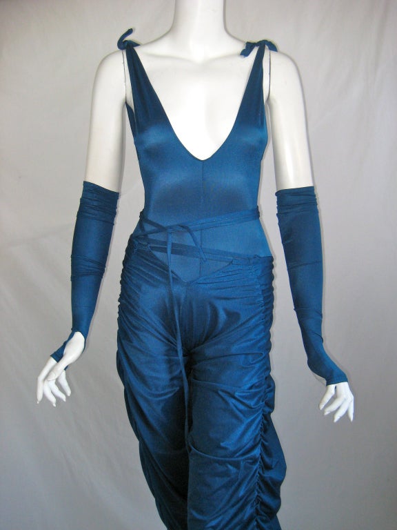 High cut Kamali bodysuit ties at shoulders and can be adjusted 
Wrap around ties on pants can be worn different ways 
Matching arm cuffs have thumbholes