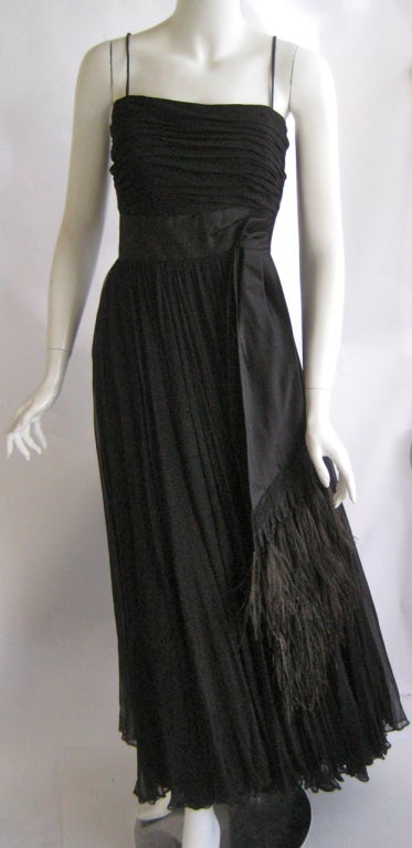 Stunning black silk evening gown
Feather trim swag at waist 
Matching feather trim stole
Silk crepe under sheath
Skirt consists of 4 layers of silk chiffon
Boned attached rayon corset