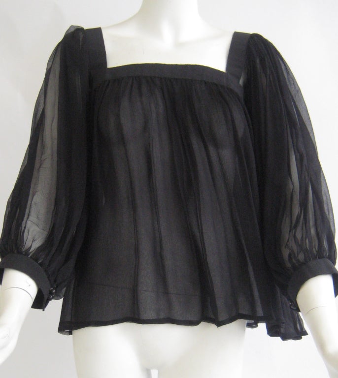 yves saint laurent peasant blouse with grosgrain yoke
fastens with two buttons under one arm 
two matching buttons on each cuff
100% silk chiffon 
excellent condition with one pinhole to the front {see pic } and one pinhole to the sleeve