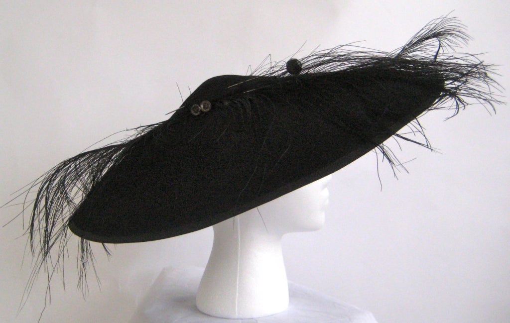 wide brim hat from gilbert adrian 
wool felt
black feather
black glass and metal hat pin