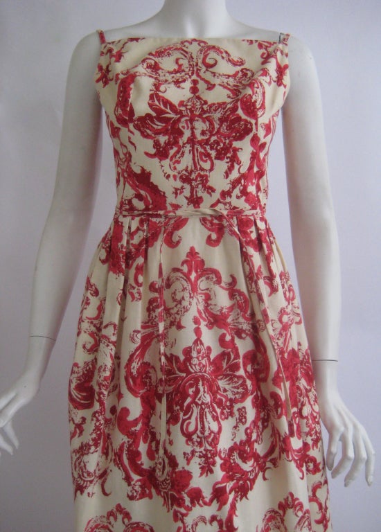 Lovely Nina Ricci dress with the Mademoiselle Ricci label
Linen or a cotton linen blend
Metal zipper up the back 
Two attached ties in the back that wrap around the waist in front
Attached petticoat with wide horsehair hem