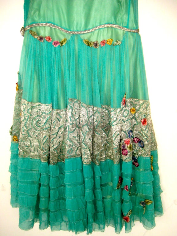 Gorgeous 1920s lame ribbon rosette dress
Possibly Callot Souers
Green silk charmeuse sheath with gold lame and teal chiffon overlay covered with ribbon rosette flowers
Twisted gold lame braid at hip