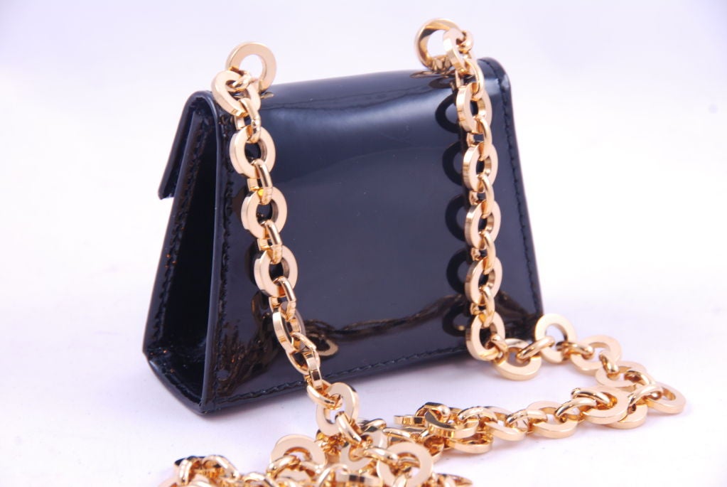 Cutest gold chain belt with black patent leather mini purse that opens. This could also be worn as a necklace. Belt measures about 44