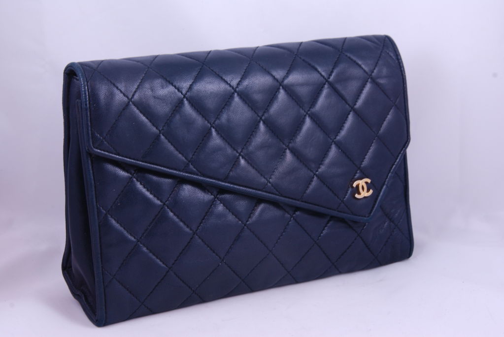 Classic, vintage navy blue quilted purse. This purse is from the 1980's and can be used as a clutch or a shoulder bag. It has a gold tone chain which measures about 29
