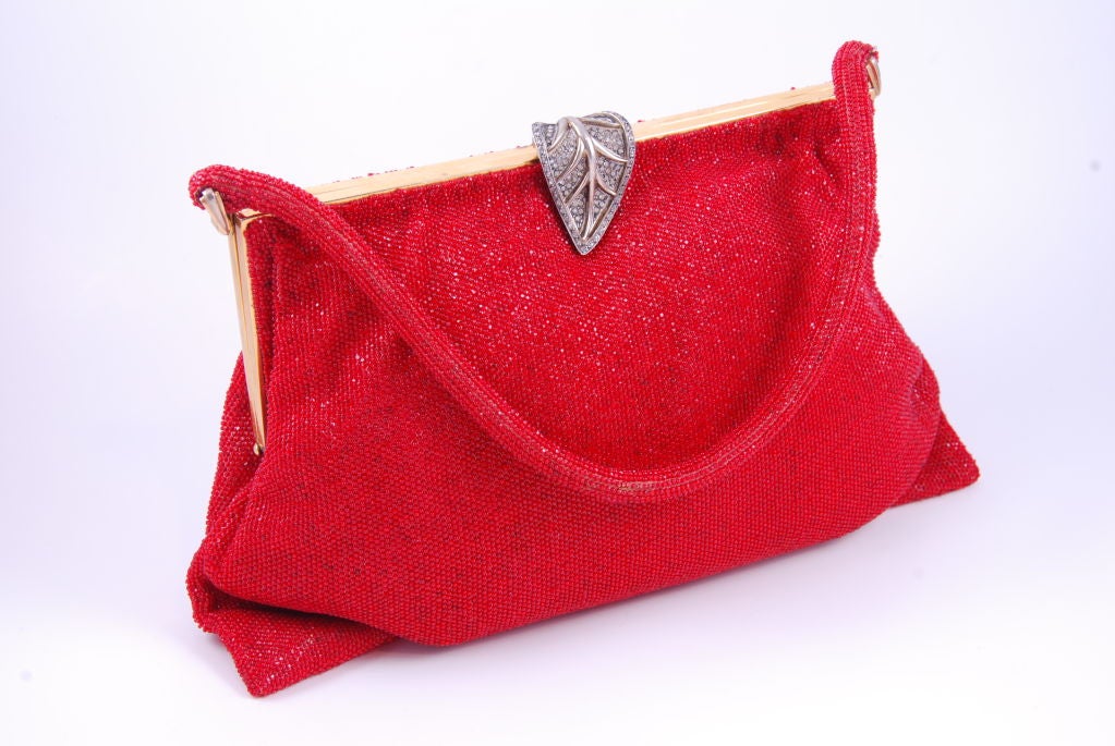Morabito red beaded evening bag with beaded handle. The clasp is hallmarked silver. The silver leaf is studded with well cut rhinestones. Clasp closes securely and measures 1.5