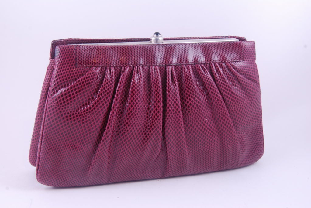 Simple Judith Leiber burgundy clutch/shoulder bag from the 1970's. There is an optional silver shoulder chain with a 14.5