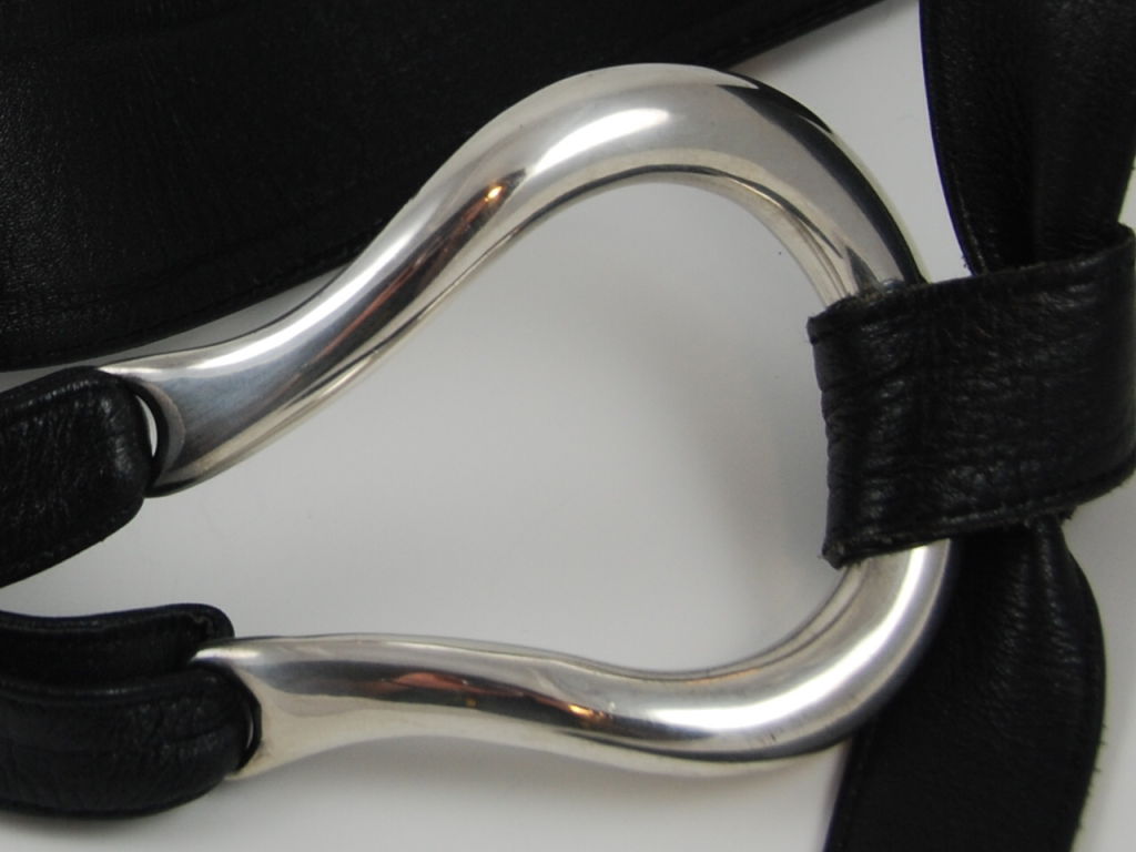 Elsa Peretti sterling belt buckles on butter soft leather belt. The design and manufacture of this belt is from the 1970's. Belt is adjustable and closes by knotting the leather through the sterling silver buckle. Buckle measures about 3