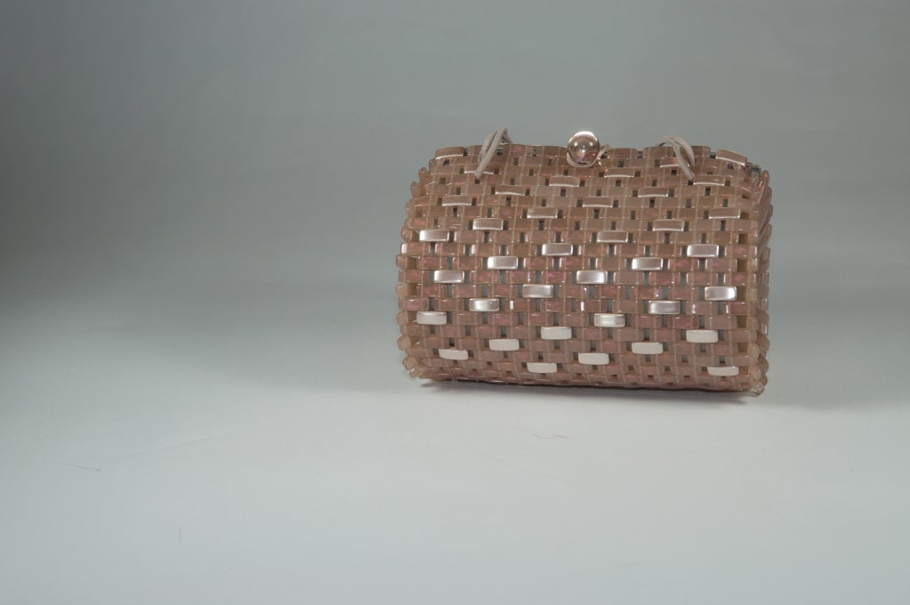 Giorgio Armani pink and gray purse in basket weave design made of flexible plastic bars, some are semi-transparent and some are opaque. The opaque bars are pearlized. The barsare backed with gray satin and the lining is gray satin as well. Closure