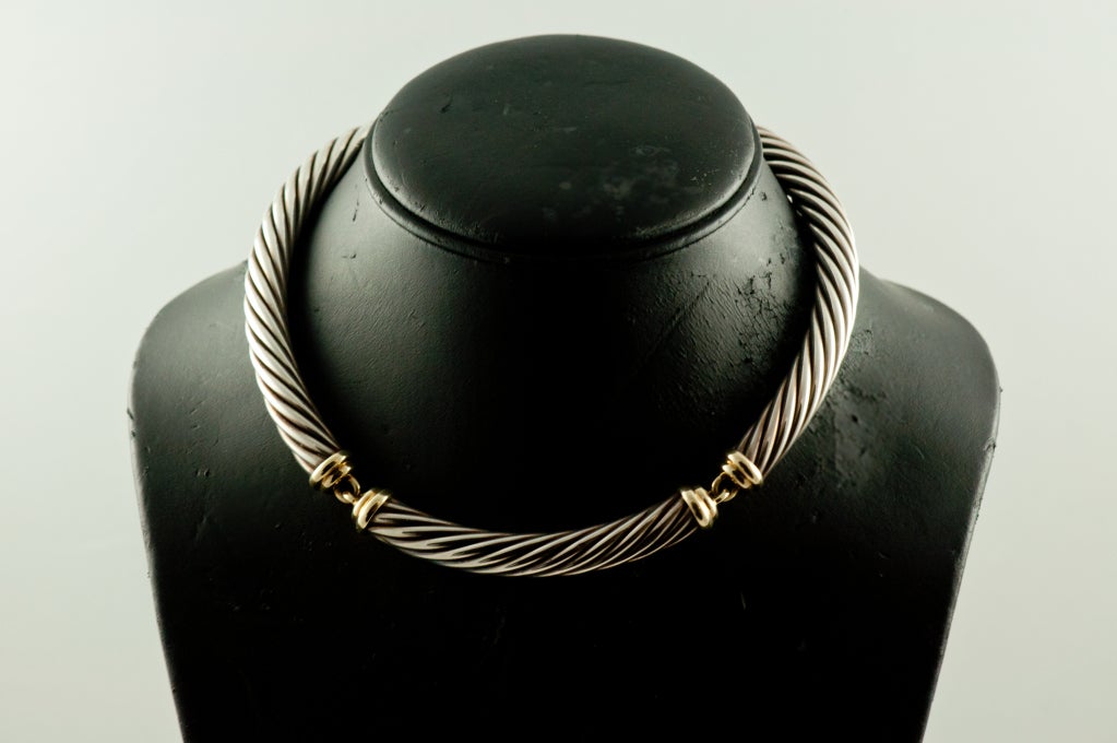 David Yurman twisted sterling silver cable necklace with 14k gold accents and links. There are three large links  but there is movement to the piece because of the links. Classic Yurman. Length is 15