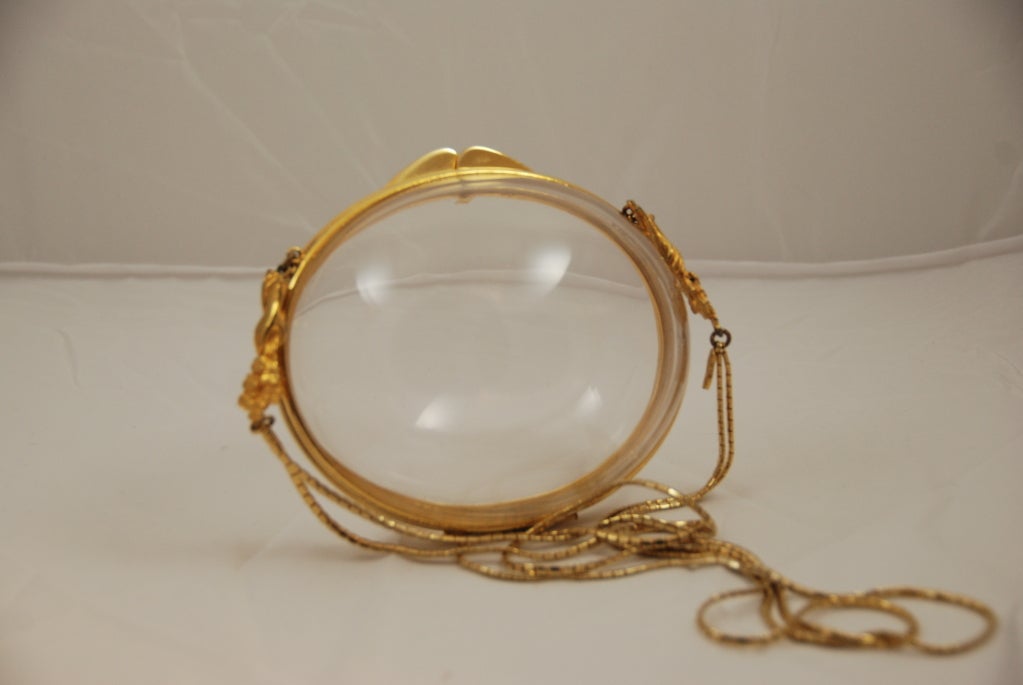 Judith Leiber clear lucite minaudiere from the early 1970's with gold chain and gold trim. The chain has about a 15.5
