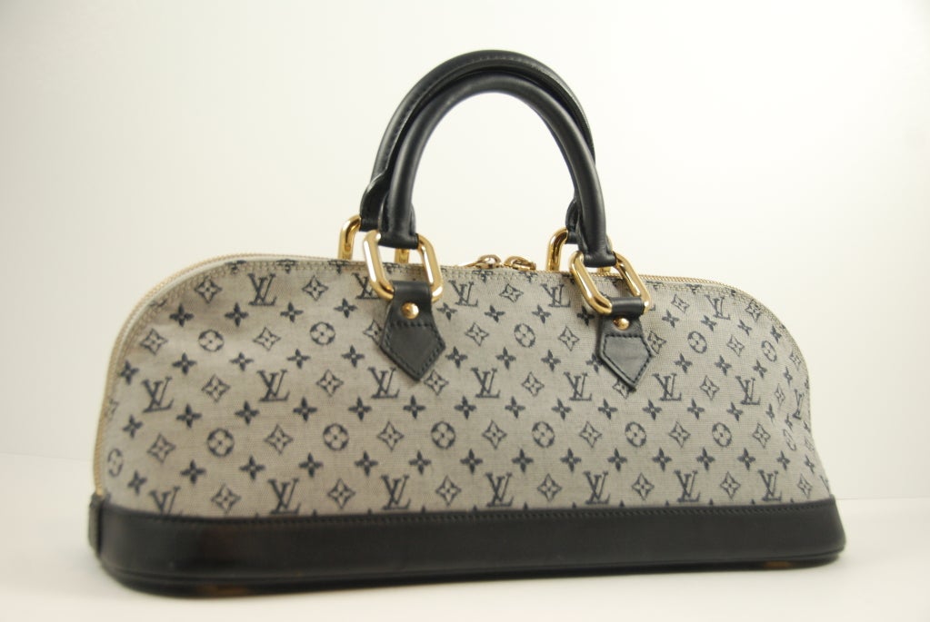 Louis Vuitton Alma bag in monogram idylle with navy blue leather trim, The bag is in excellent condition except for one water type stain on the inside lining.

Handles measure about 12