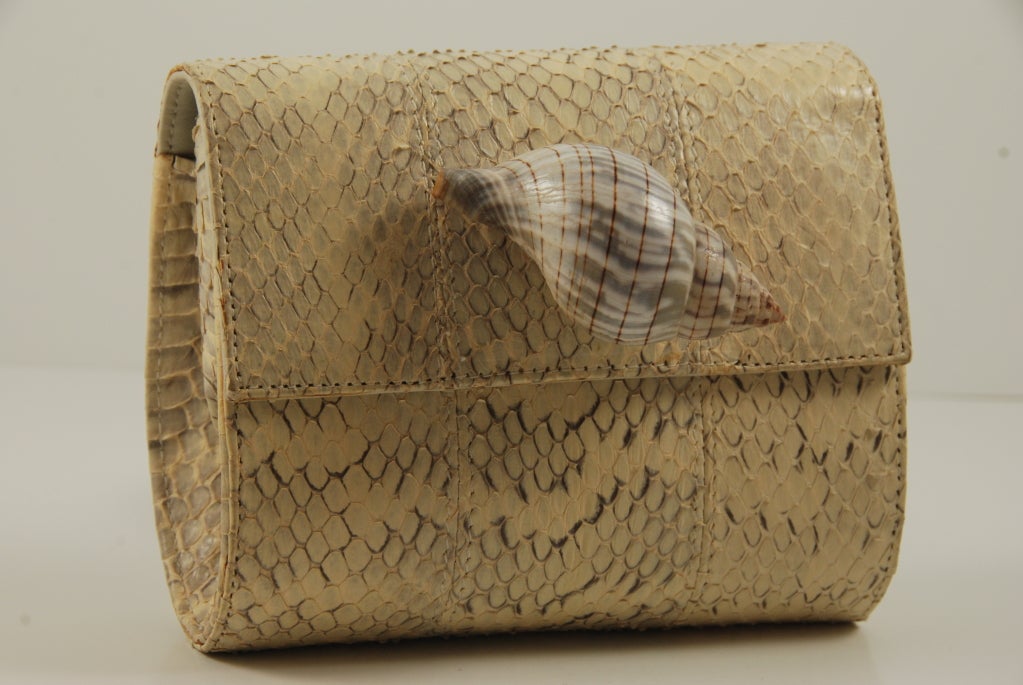 Small python bag by Yves St. Laurent haute couture in off white and grey python. The large shell on the front of the bag is real. Bag closes by a hidden magnet under the python skin. The is a detachable strap that has a 9.5
