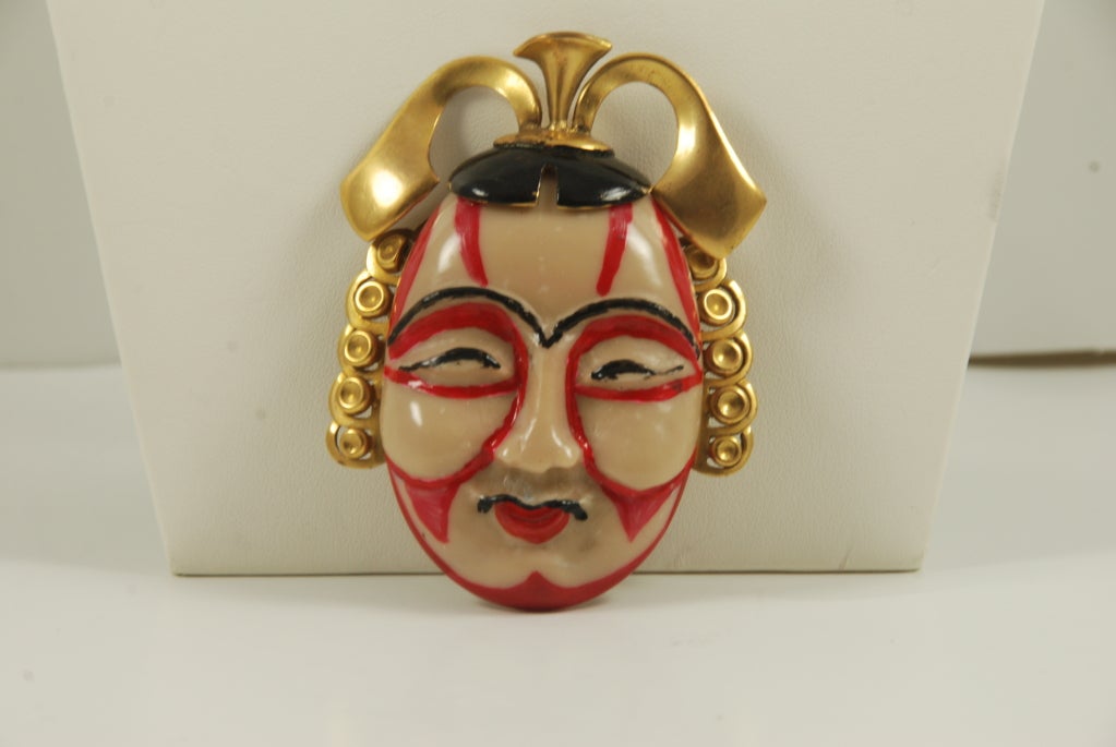 Asian motif Valentino brooch. A most unusual item. The face is hand painted and appears to be made of some type of resin. The 