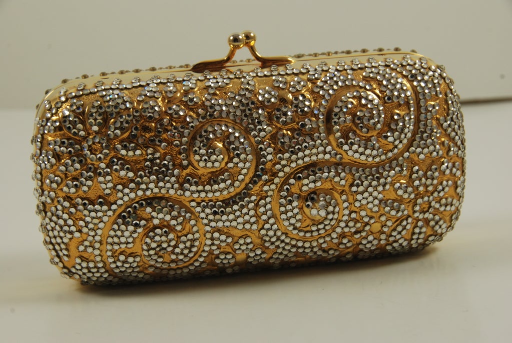 Charming Judith Leiber minaudiere, probably from the 1970's. The rhinestones are in a raised monochromatic paisley pattern. The chain has a drop of 13