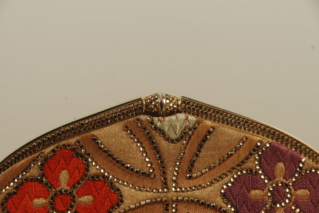 Elegant Judith Leiber evening bag studded with topaz colored rhinestones. The material of this bag is made of antique obi fabric from Japan. The concept for the Leiber obi bags started in the 1970's with Neiman Marcus in Texas to coincide with a