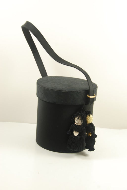 1980's vintage Renaud Pellegrino black moire & satin amusing evening bag with two charming figures hanging from the side. I was told by the lady who sold this bag to me that the store in Paris called this the Tristan and Isolde bag. The bag opens by