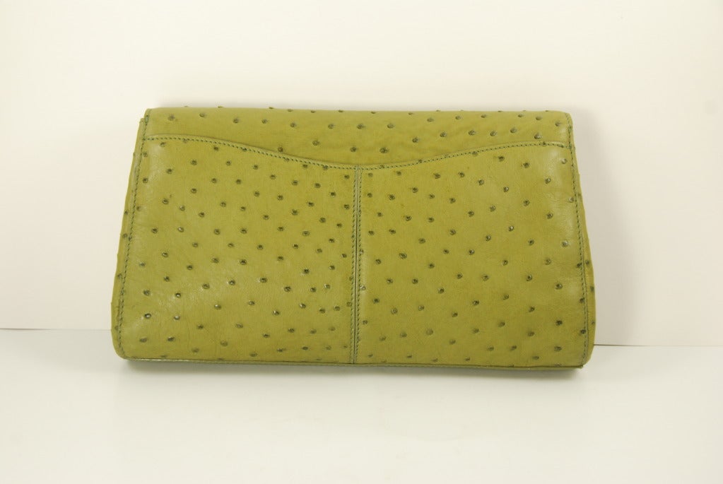 Fabulous green ostrich clutch by Cece Cord (half of the Kisselstein Cord design team).The condition is pristine and the skins on this bag are supple.  The clasp is magnetic and is hidden underneath the skins. Clasp works well and bag closes