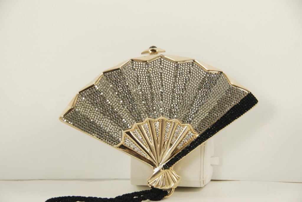 One of Mrs. Leiber's most popular minadiere designs, the fan. This one is done in crystals of jet black, black diamond and clear. There is an chain shoulder strap that folds into the bag when not in use. Bag can also be held has a clutch or by the