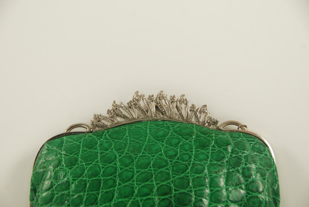 A green alligator and marcasite frame handbag re-created by Jacomo. The silver tone frame has a floral border  studded with marcasite. Jacomo had a store on Madison Ave in NYC in the 1980s. He collected vintage and antique frames. Customers would