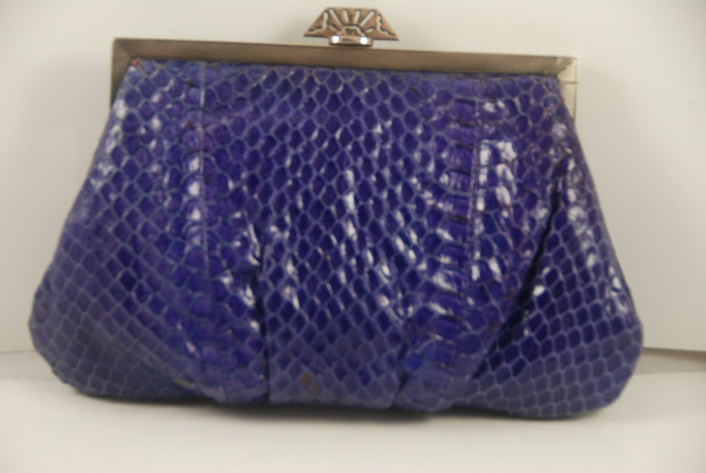 Purple python clutch with sterling silver and marcasite antique frame. The frame has Englilsh hallmarks and from that we can tell that the frame is sterling silver, made in London in 1933. The work on the frame is engine turning. 

Jacomo was a