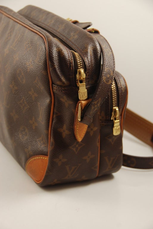 Classic Vuitton handbag in the sturdy monogram canvas. This is a spacious bag with a large main compartment and a smaller zippered outside compartment. Great for city life or traveling when you dont want to have to open the main part of your purse