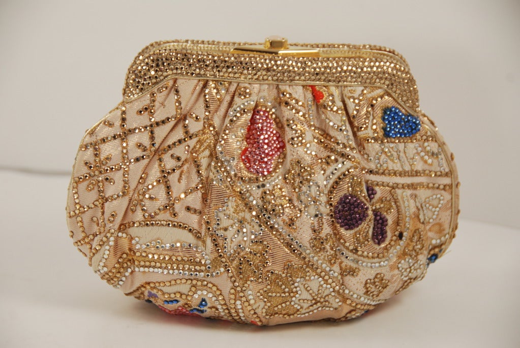 Delightful obi bag from Judith Leiber. The obi bag was created by Mrs Leiber by request of Neiman Marcus for their themed event about Japan. Antique obi fabrics were embellished with rhinestones and turned into evening bags. The concept was so