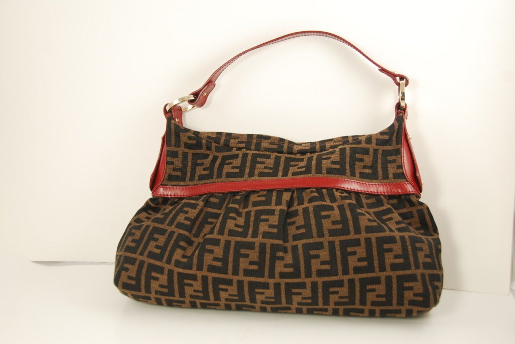 Fendi handbag in Zucca-print jacquard with red leather trim and handle.Strap has a 7.5