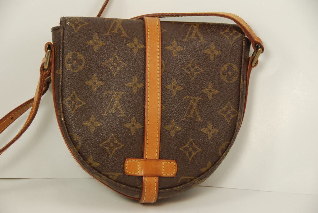 This is the 1970s version of the Vuitton classic Chantilly bag in the smaller size. This classic bag has a great contemporary urban look. Meant to be worn cross body the bag closes securely with a brass buckle closure. Comes with the shoulder pad