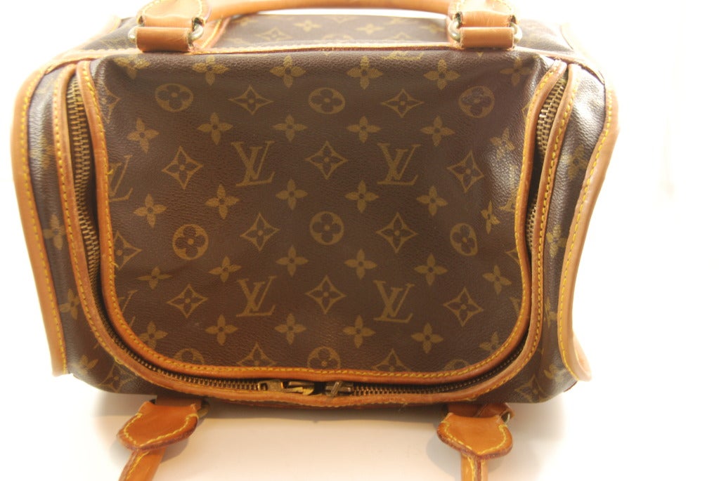 Louis Vuitton train case in the monogram canvas with leather trim and handles. Made in France, this case dates from the 1960s.  Opens by way of two zippers that work in opposite directions, the flap flips back and the bag opens wide. Zippers work