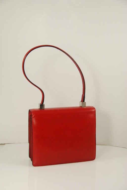 Wow, what a find! Fabulous  smooth red leather Pierre Cardin handbag with 3 chrome horse nails across the front. Bag opens with a pin lock, which works well, closes with a click and is secure.  There are two main compartments in the bag and two slip