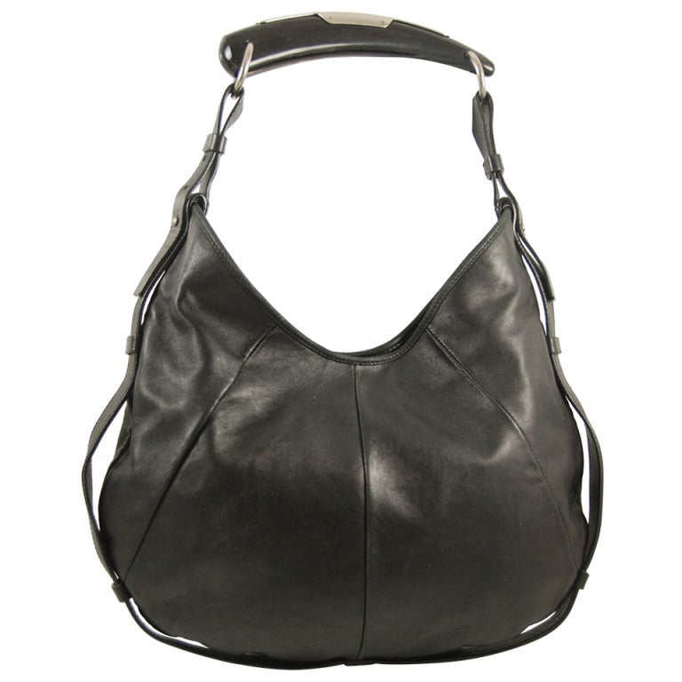 Sold at Auction: Yves Saint Laurent black leather Mombasa sling bag with  horn detail to shou