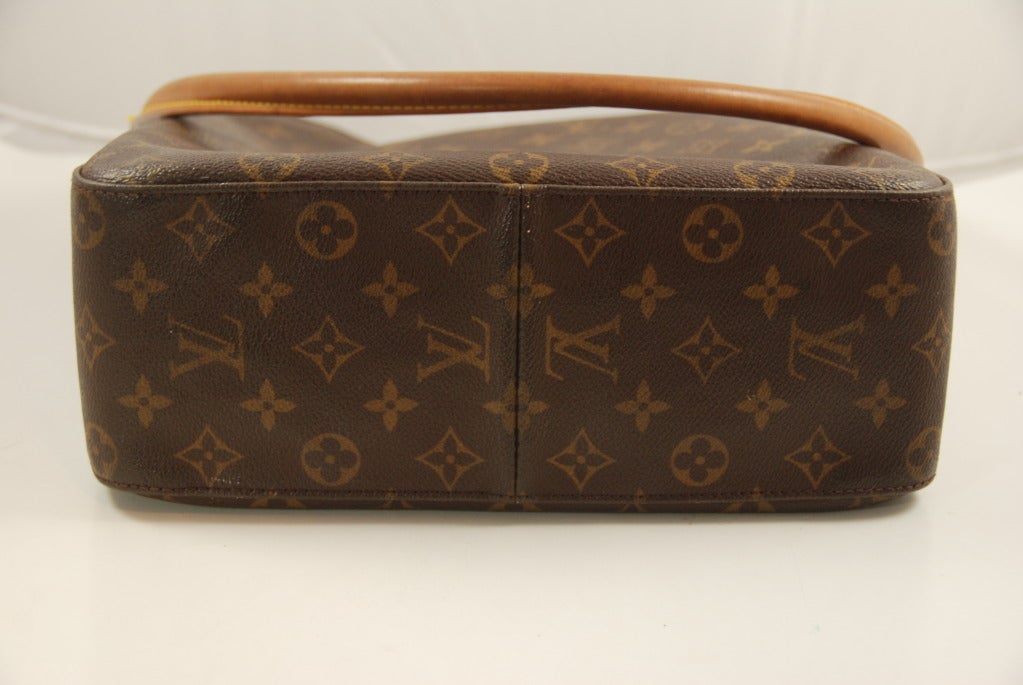 Louis Vuittonshoulder bag in iconic Monogram canvas. The handle is the LV natural cowhide leather that feels great to the touch, wears well and naturally darken with age. These classic LV bags are the work horses of the fashionable. These bags wear