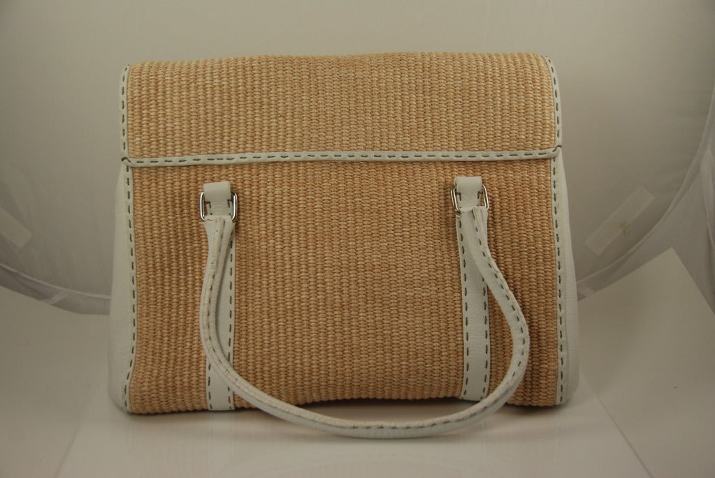 Fendi Selleria bag in white leather and woven raffia. The Selleria line was started by Fendi in 1995 and these bags are entirely hand carfted. Matte grained leather flap front bag with rolled top handles that have a 5.5