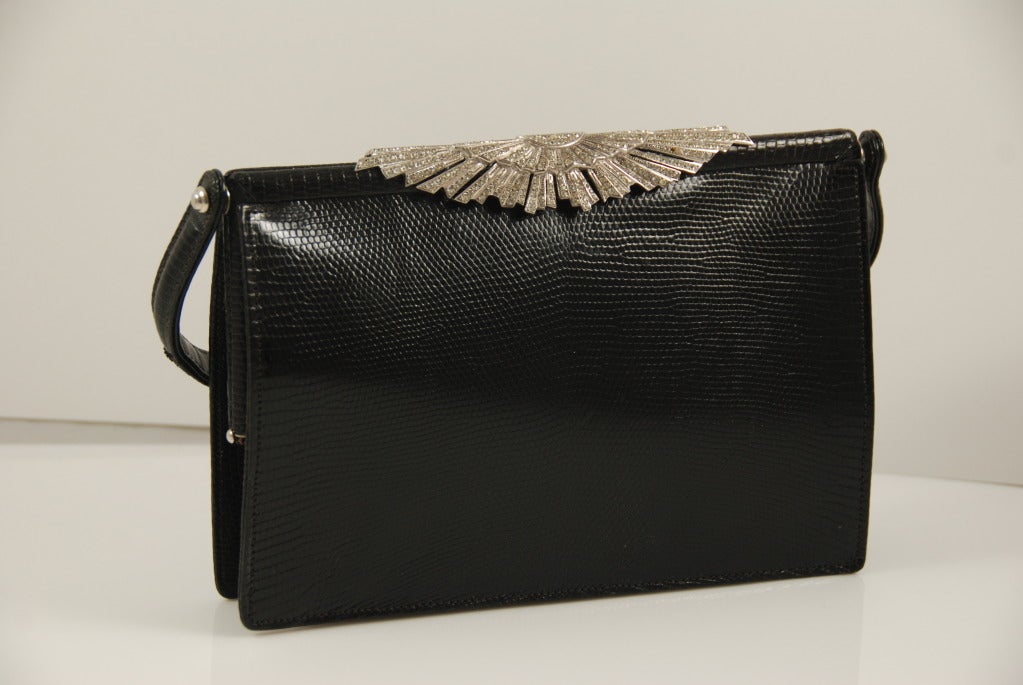 Exquisite black lizard bag by Koret from the 1950s-60s. Retailed in the US, this bag was made in France. The rhinestones in the Art Deco style clasp are cut like mine cut diamonds ( a cut of diamonds from the late 1800s early 1900s). The clasp works