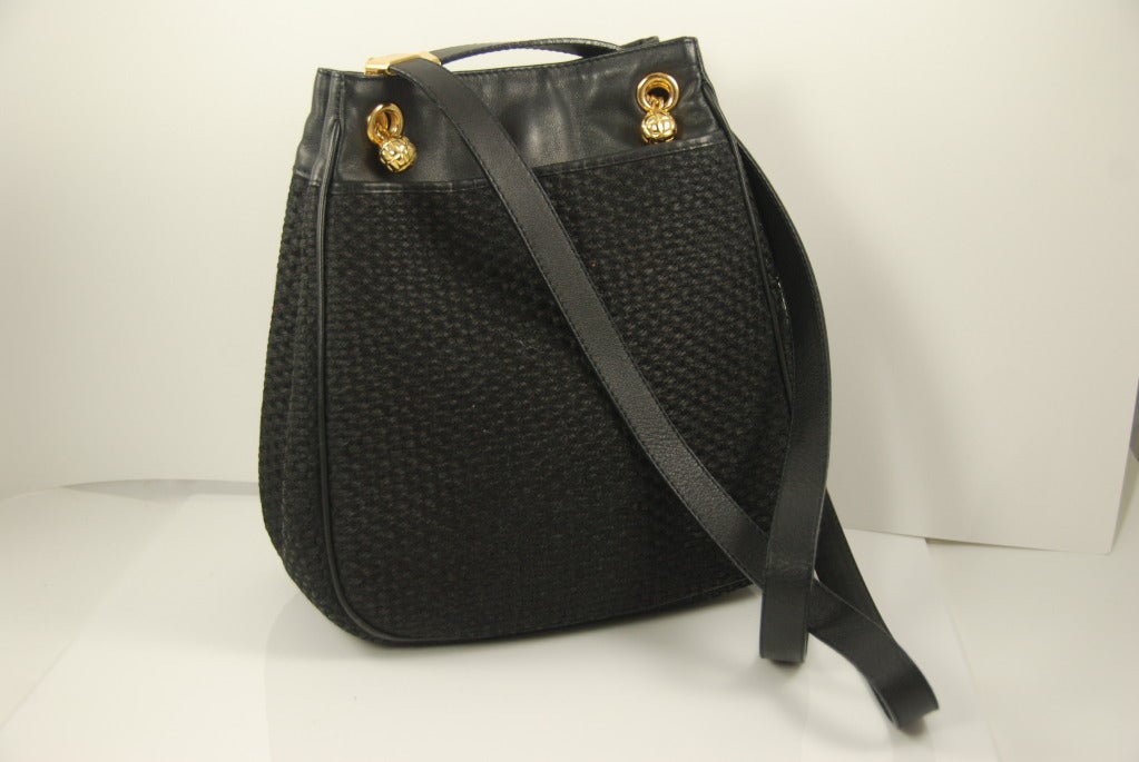 Fantastic black  Bottega Veneta shoulder bag with woven fiber body I am not sure what this fiber is called but is a cross between raffia and hemp. The trim, pipping and handles are made of very soft leather.  Bag is in pristine condition. Closure is