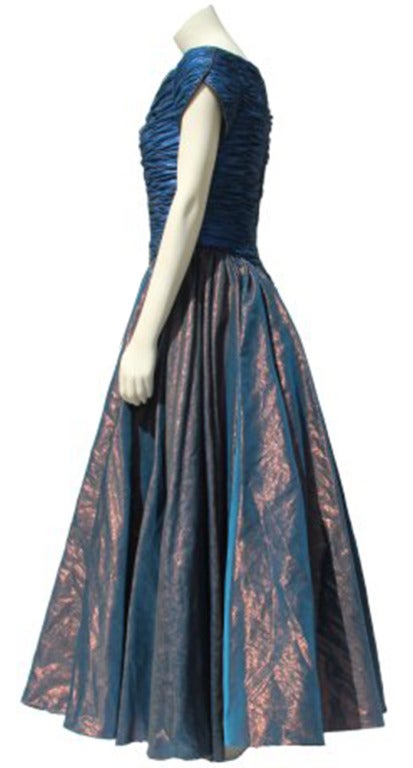 Important Catherine Walker silk and silk organza evening gown from 1990 - the gown features a ruched bodice and layered skirt with bronze metallic effect, enhanced by tiny crystals to one of the underskirts. The late French-born Royal couturier
