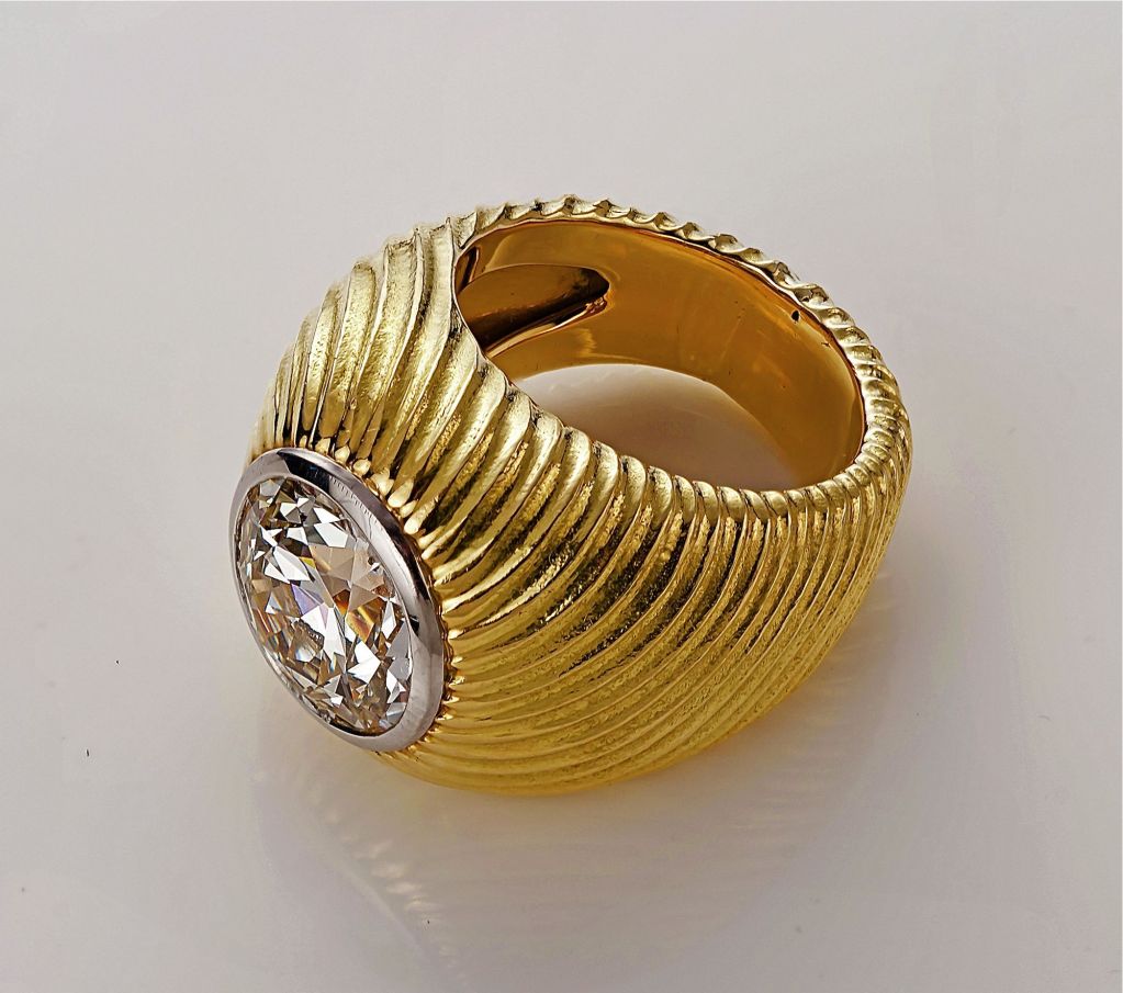 An impressive round diamond 6.05tcw set in a large signet ring designed as ribbed whorl enrobing the platinum set fine diamond made by Schlumberger for Tiffany