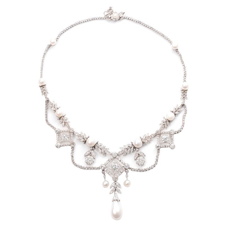 An extremely fine diamond and Oriental pearl  Louis XVI Garland Style necklace mounted in platinum.