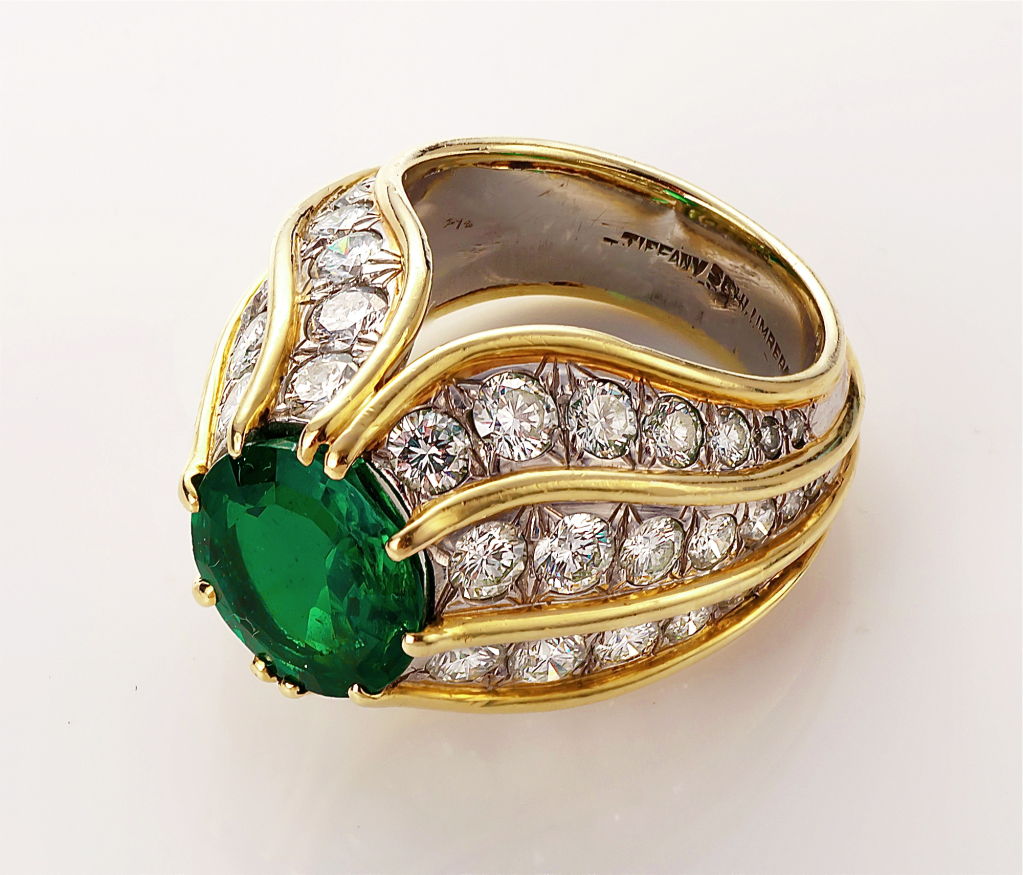 A very fine Colombian octagonal natural emerald, mounted with diamond in a gold and platinum setting, turban style.  By Schlumberger for Tiffany.