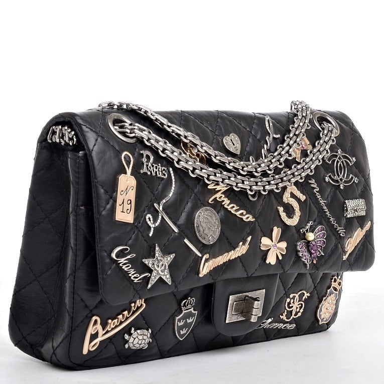 Chanel rare first edition black quilted distressed calfskin leather Lucky Charms 2.55 reissue double flap bag in size 225 featuring 25 iconic Chanel charms (such as Number 5, CC, Coco, Star, Four Leaf Clover, Flap Bag, Turtle, Coat of Arms,