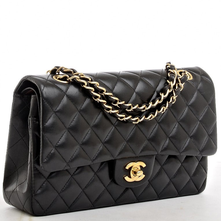Chanel black quilted lambskin leather Large classic 2.55 double flap bag with goldtone hardware, front flap with CC turnlock closure, half moon back pocket and adjustable interwoven goldtone chain link and black leather shoulder strap. Interior is