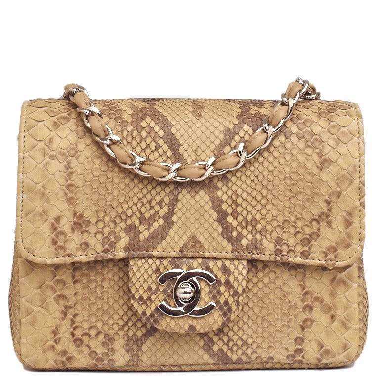 Chanel natural python Mini classic flap bag with silvertone hardware, front flap with CC turnlock closure, half moon back pocket, and interwoven silvertone chain link and beige leather shoulder/crossbody strap. Interior is lined in beige leather