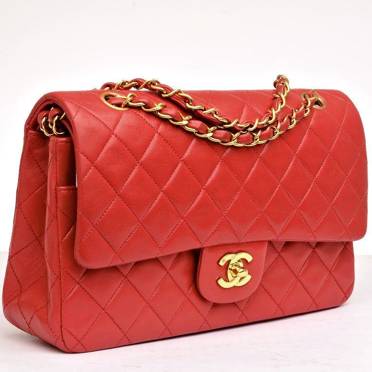 Chanel red quilted lambskin leather Large classic 2.55 double flap bag with goldtone hardware, front flap with CC turnlock closure, rear half moon pocket. and interwoven goldtone chain link and red leather adjustable shoulder strap. Interior is