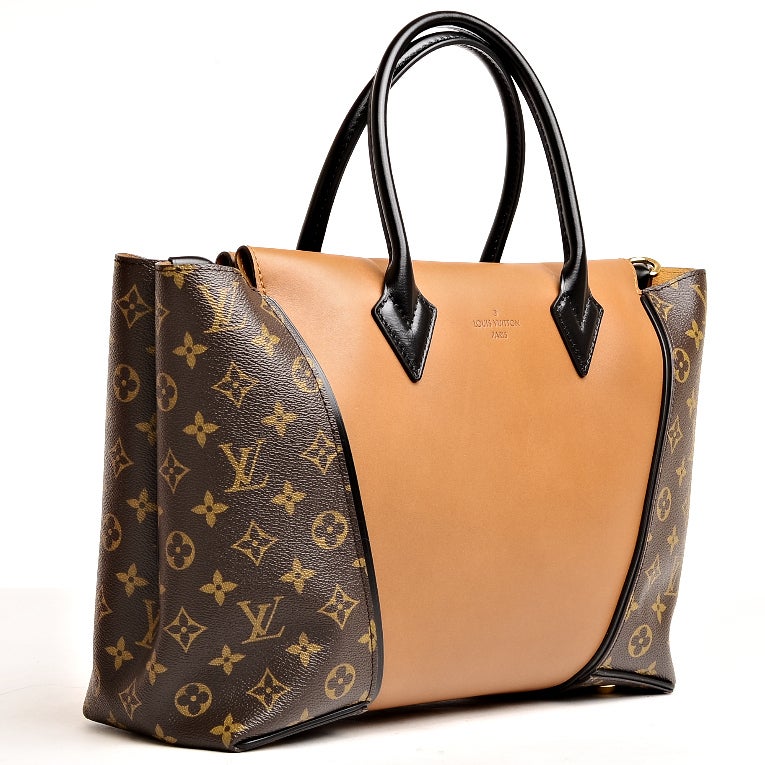 Louis Vuitton W PM of Noisette Cuir Orfèvre calfskin and Monogram coated canvas sides, golden brass hardware, black smooth leather trim, tonal stitching, hidden magnetic closure, double rolled handles, and light brown suede interior with zipper