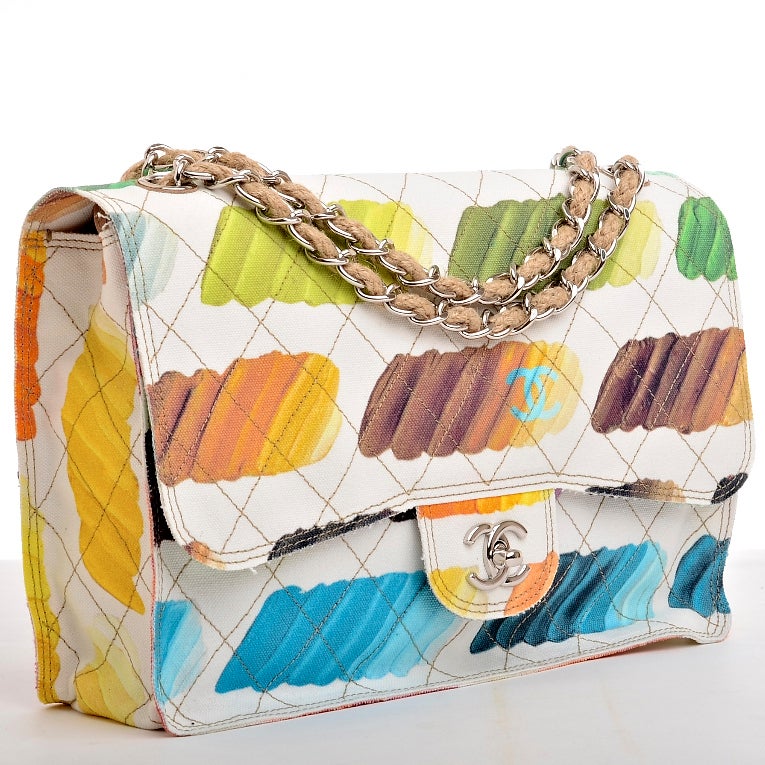Chanel multi-color quilted Paint Palette canvas flap bag featuring all over colorful paint brush print in shades of of blue, green, pink, purple, yellow, orange, red and brown on white canvas with contrast beige stitching with silver hardware, front