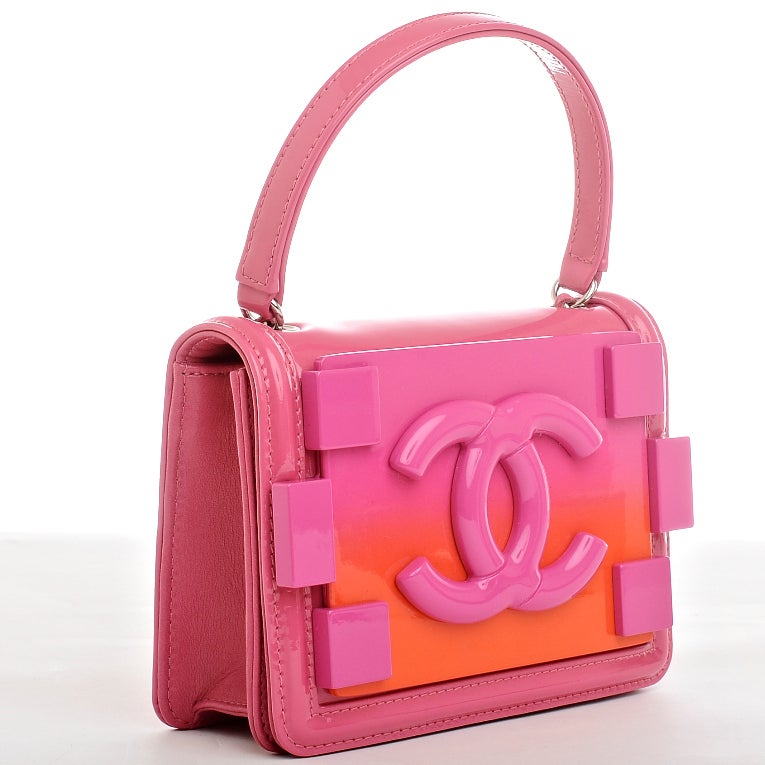 Chanel pink lambskinand patent leather Boy Brick crossbody bag with silvertone hardware, front large pink CC logo on pink ombre plexi glass plate with surrounding 6 stud detail, hidden snap closure, flat back pocket with quilted pattern and
