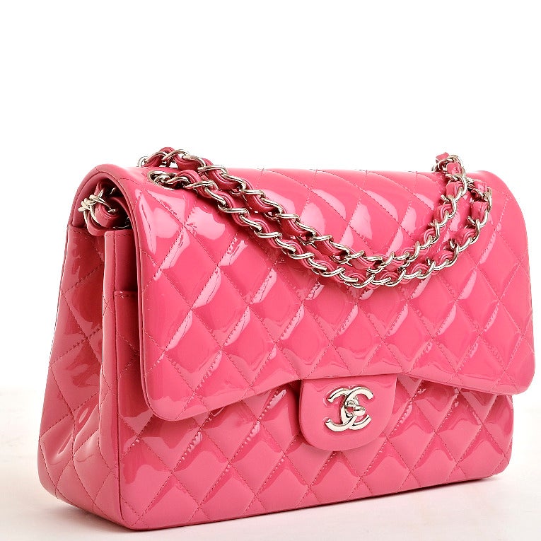Chanel fuchsia pink Jumbo Classic double flap bag in quilted patent leather with silver tone hardware.

This limited edition Jumbo Classic double flap bag of bright fuchsia quilted patent leather with silver tone hardware features a front flap